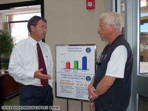 Healthy Banks: Peoples Bank President Todd McKee, left, chats with customer Tommy McVay on Friday in Lubbock, Texas.